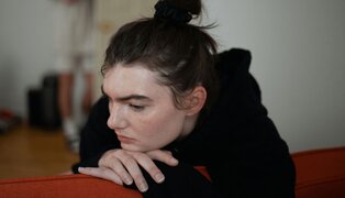 Woman resting on couch contemplating domestic abuse worksheets