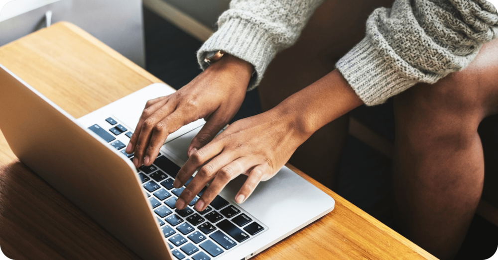 A therapist types up GIRP notes on a laptop, following the format of GIRP notes examples