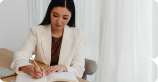 woman writing soap notes in notebook