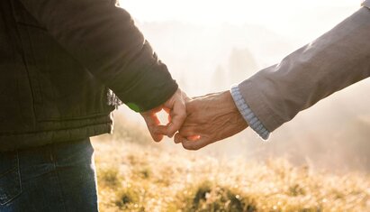 closeup of two people holding hands showcasing positive qualities in a partner