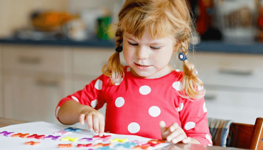 little girl using a rewards and consequences chart