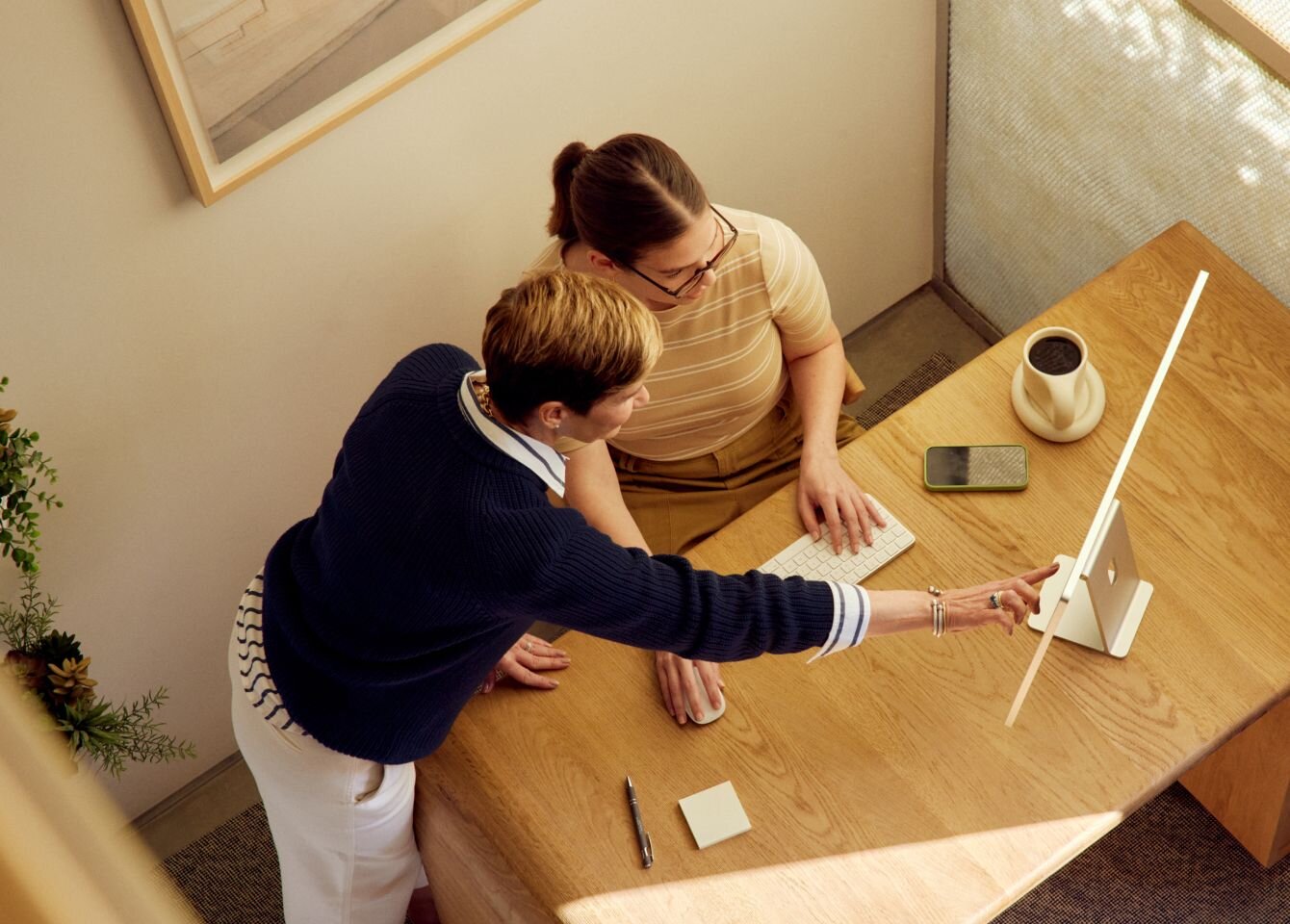 Practitioners using management software on desktop computer