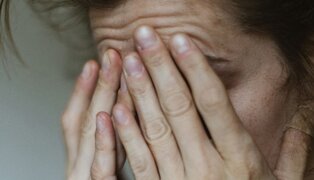 person pressing their hands to their face