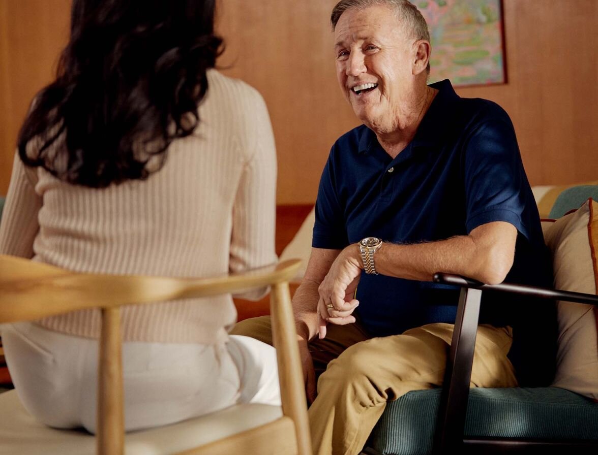 Older client in chair talking with practitioner