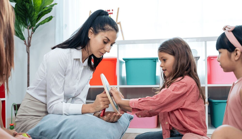An occupational therapist works with a young child on sensory integration therapy.