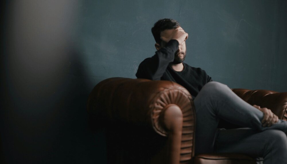 person sitting on couch after being diagnosed with anxiety with depression icd-10 code