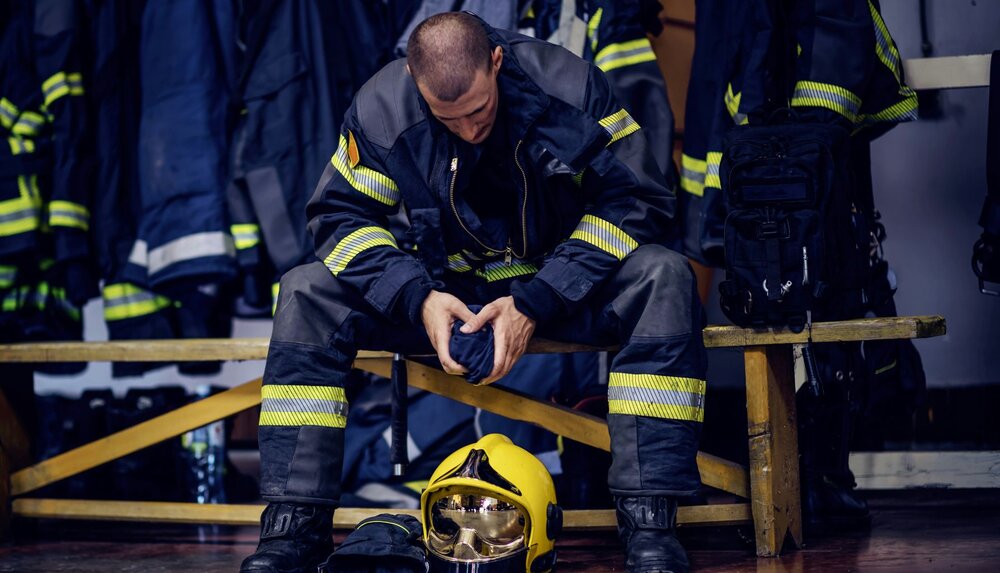 A photo of a firefighter in anguish, as they can experience much trauma on their jobs