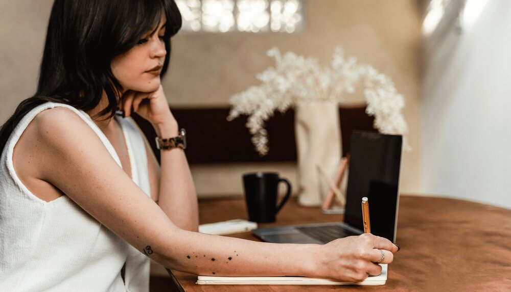 woman at her desk working on a mental health maintenance plan