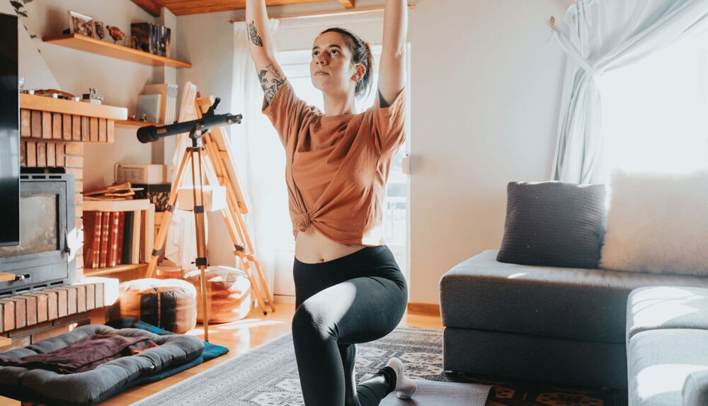 woman doing yoga after learning about the benefits of exercise