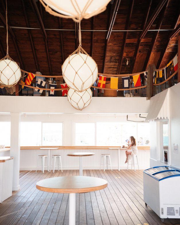 Indoor View of the Oyster Bar with high top tables 