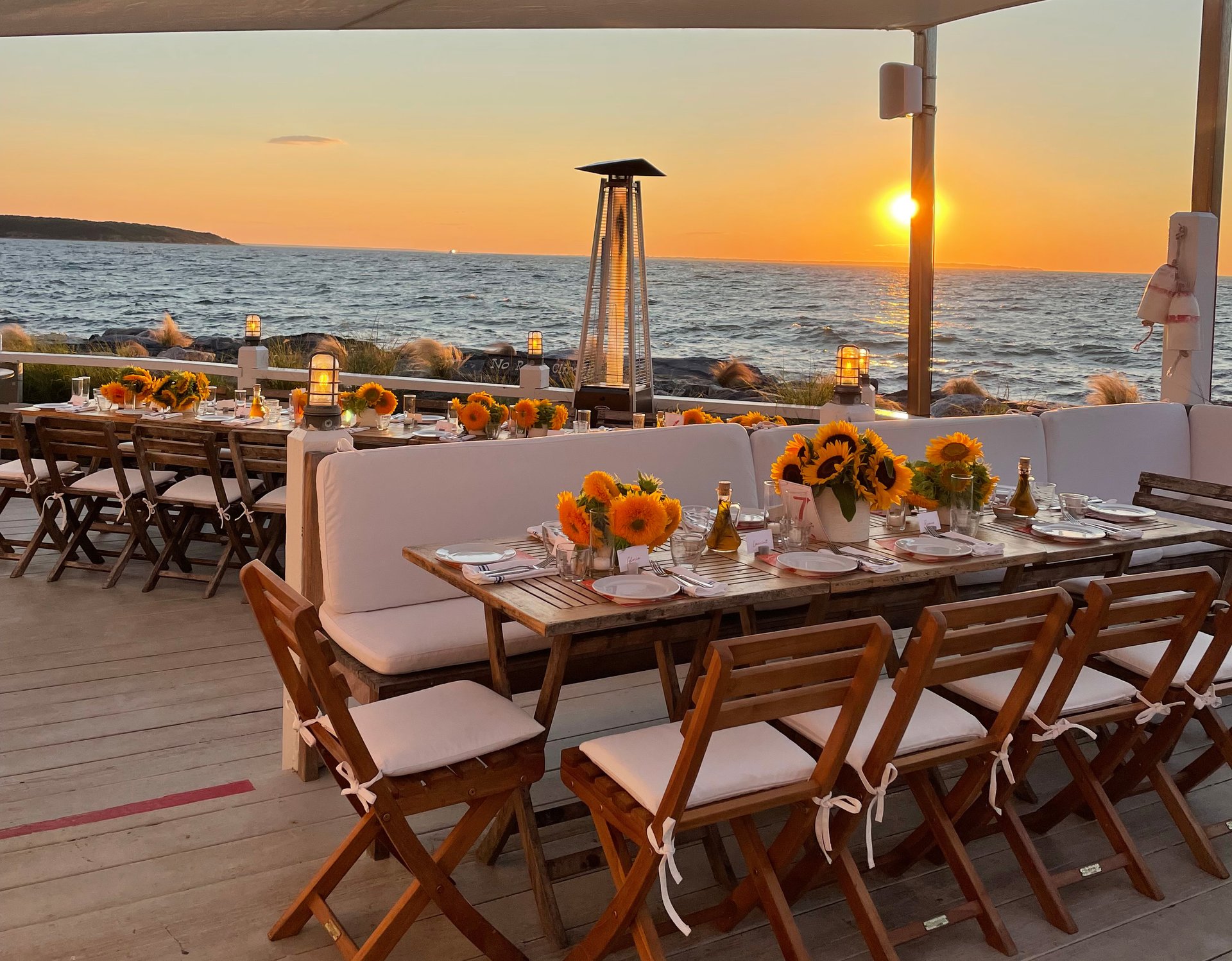 A private event hosted at Duryea's Montauk picturing a table set up with sunflowers