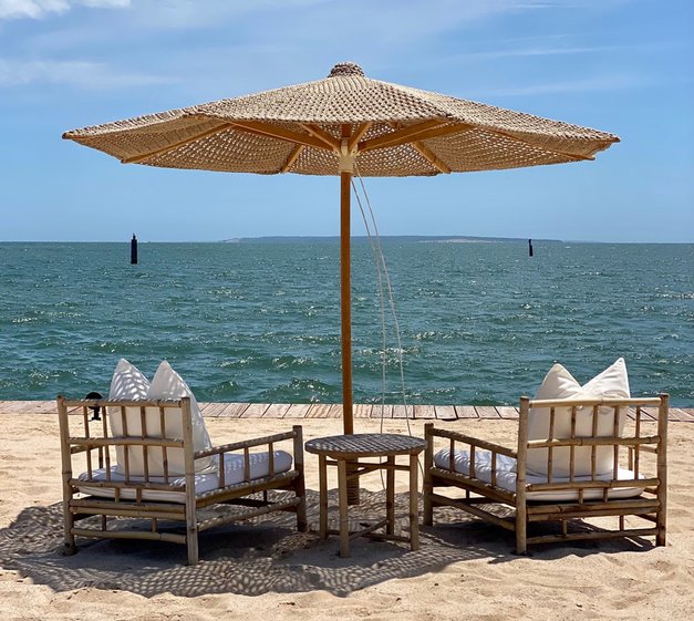 Sitting area for two with umbrella at the Beach Club at Duryea's Orient Point