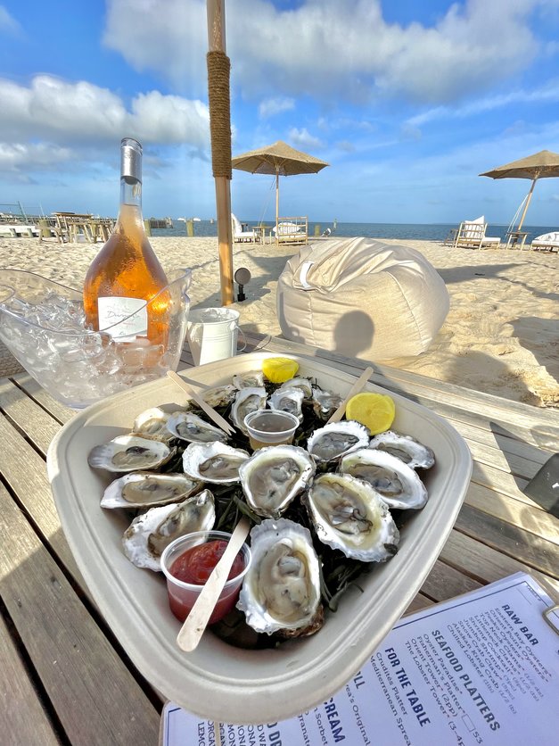 Blue skies and a platter of oysters on the half shell and a bottle of Duryea's Rose on ice