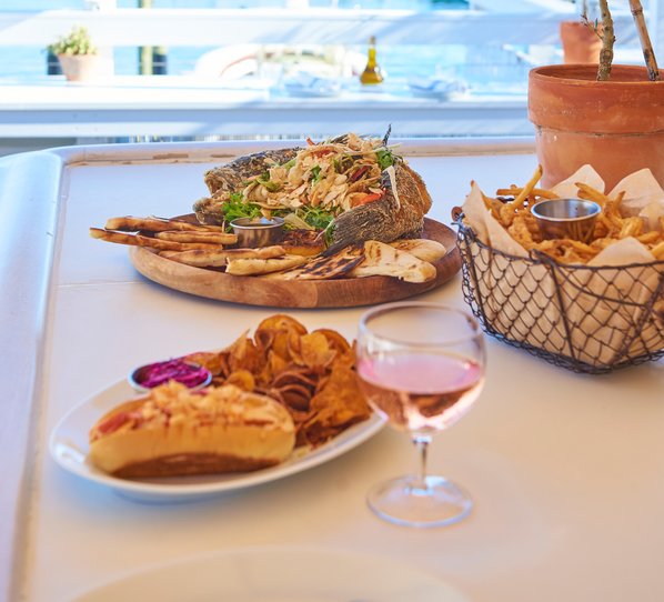 Array of different specialty appetizers including Dolmata salad, crudites, and Mediterranean platter