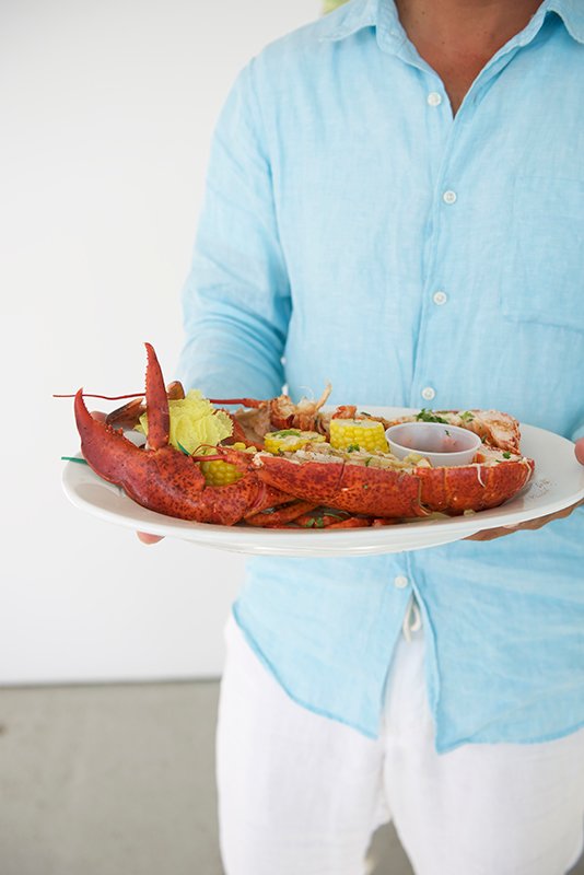 Platter of 2 lb lobster being delivered to a table