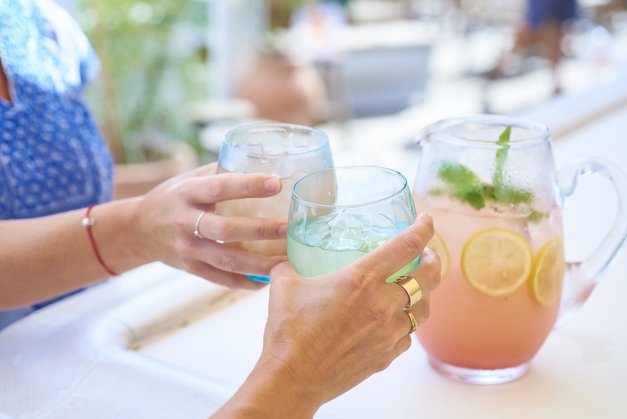 Customers toasting Watermelon margarita at the bar