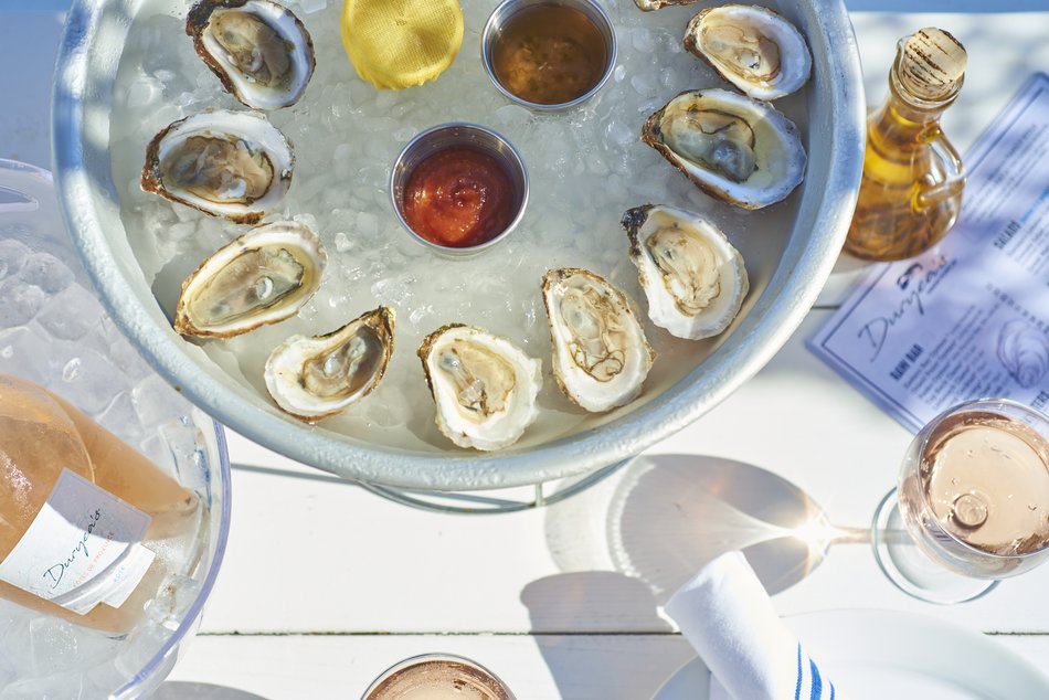 One dozen oysters and a bottle of Rose on the table at Duryea's Orient Point