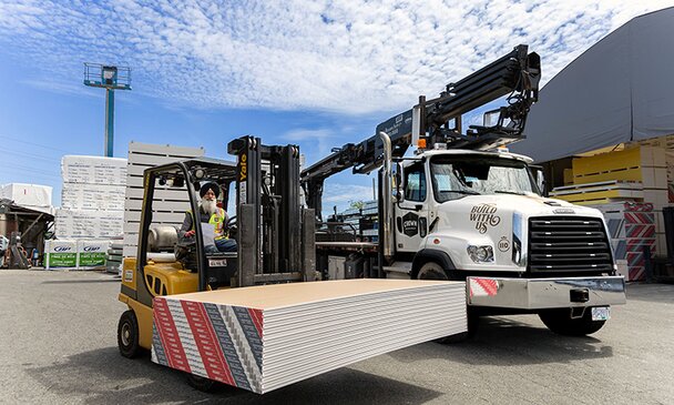 Crown Building Supply worker loading drywall in truck
