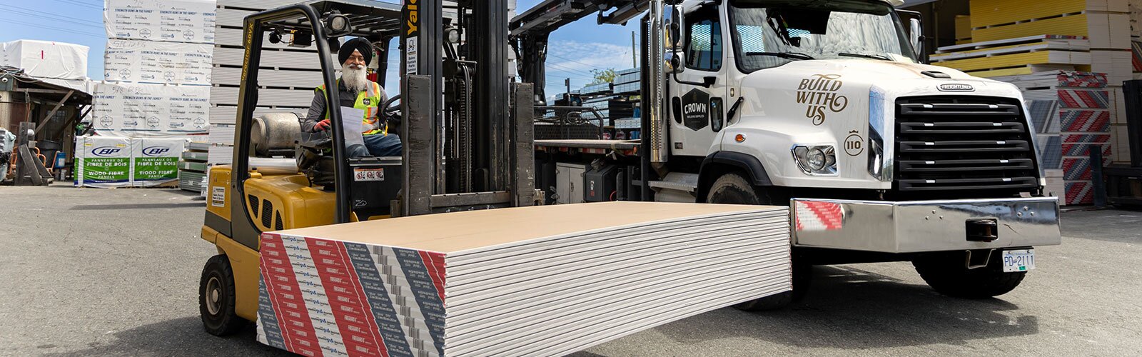 Crown Building Supply worker loading drywall in truck
