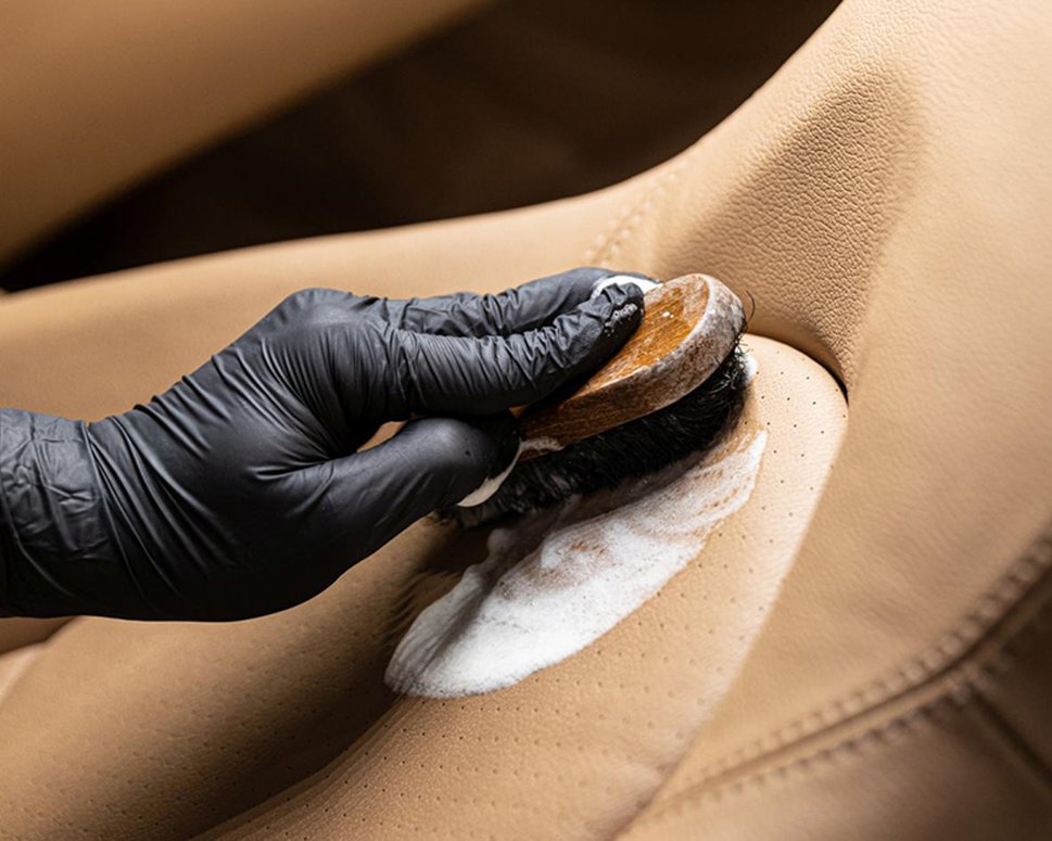 Using a brush to clean Nappa leather car seat