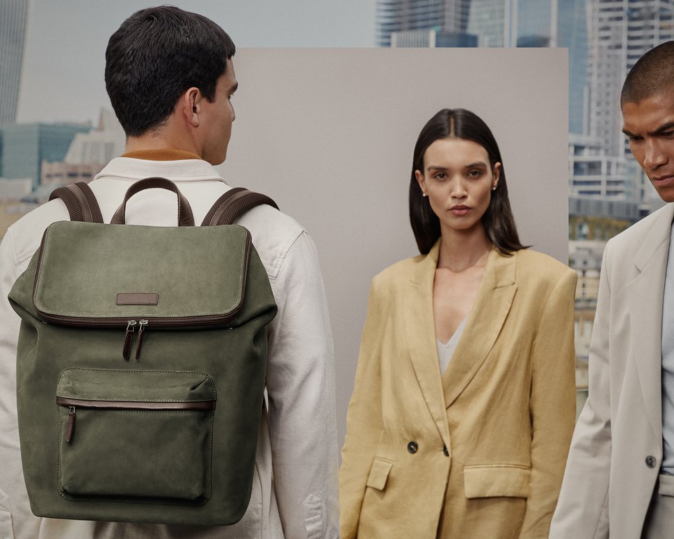 Male model facing backwards with green nubuck backpack