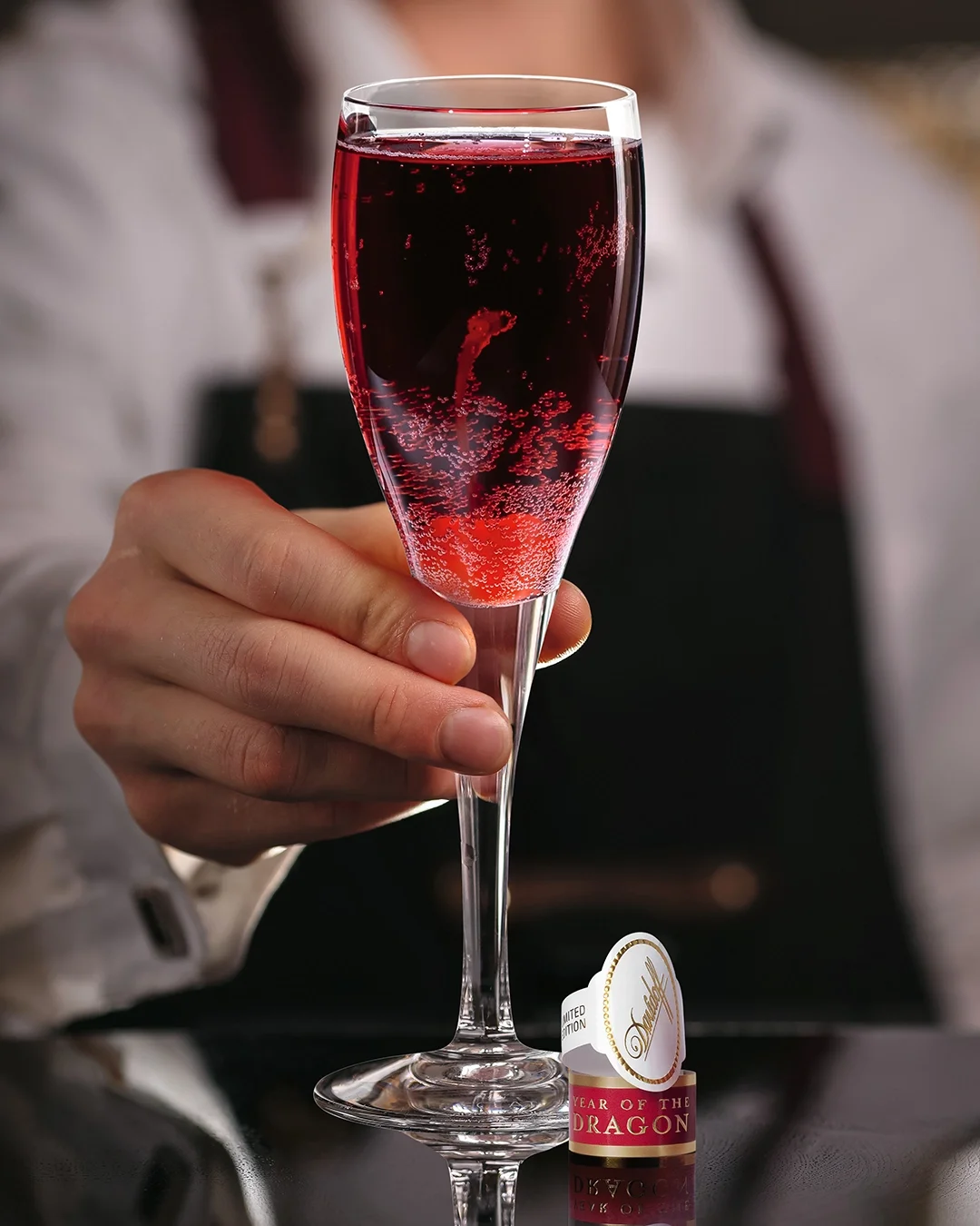 The Davidoff Year of the Dragon Limited Edition cigar leaning against one of two glasses filled with Kir Royale cocktail.
