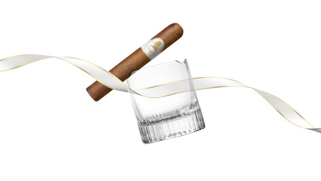 A premium cigar rests atop a crystal glass, accented by an elegant ribbon, evoking a sophisticated leisure moment.