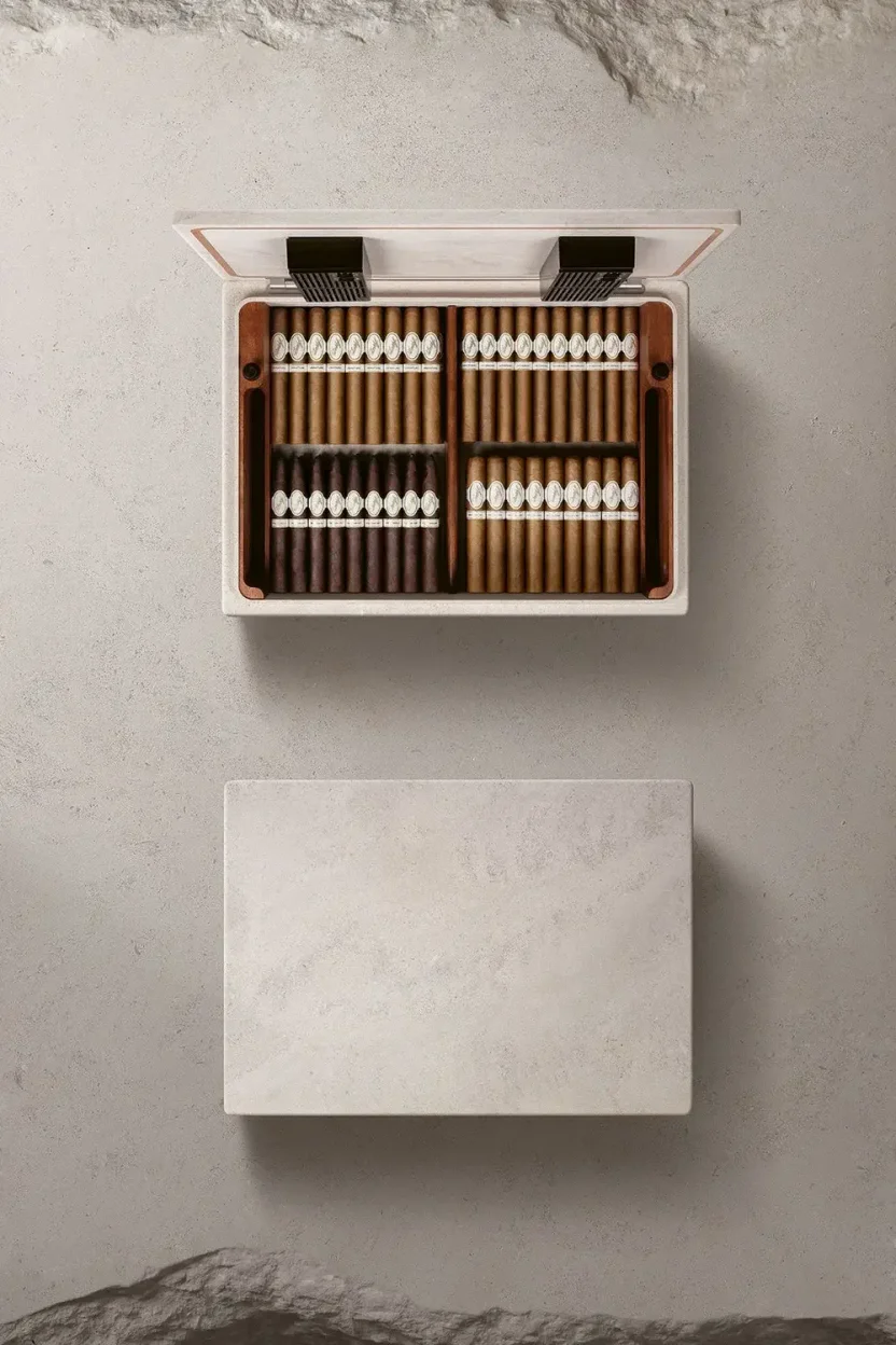 The open Davidoff Monolith humidor with neatly arranged cigars lying on a textured, light grey surface, viewed from above.