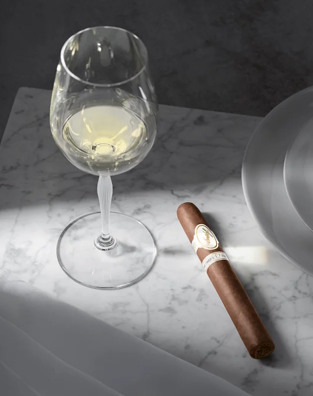 A Davidoff Chefs Edition 2205 cigar next to a white wine glass.