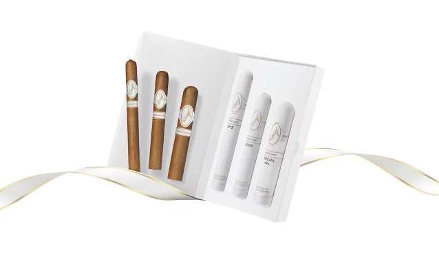 Opened Davidoff Gift Selection Tubos White Band and Black Band with cigars inside and a white and gold ribbon in the background. 