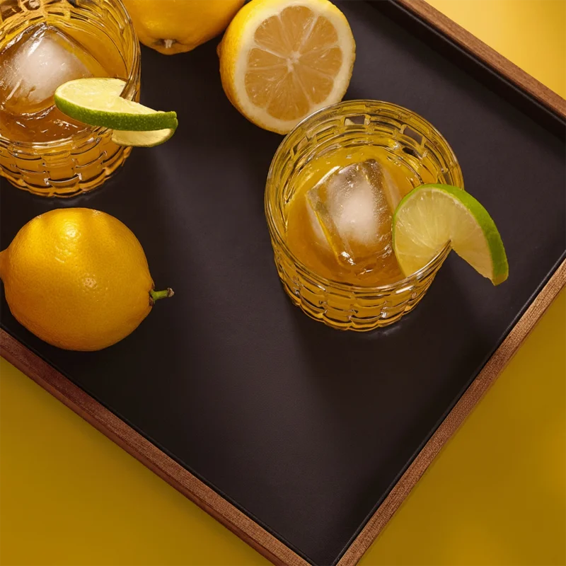 Two yellow bird cocktails shown from above next to the Davidoff Year of the Snake lancero cigar and a lemon.