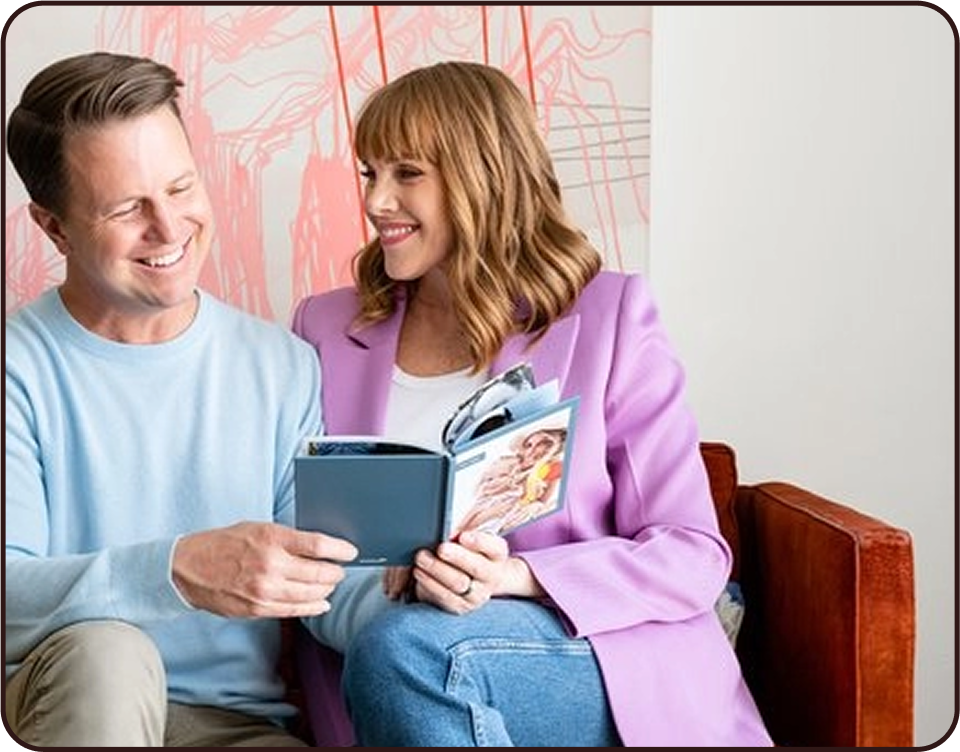 Nate and Vanessa Quigley looking at a Chatbook