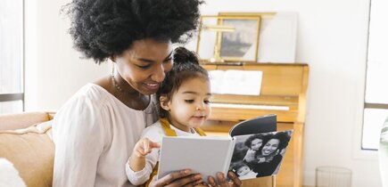 mom reading a book with her child