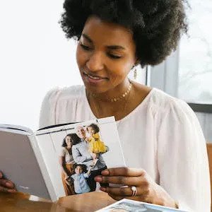 family looking at photo book with funny screenshots and quotes