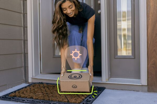 Person grabbing their Seasonal Box from their front door step 