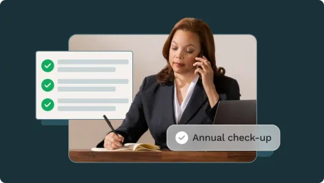 woman with brown hair works at her desk