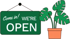 sign saying come in we're open, and a potted plant.