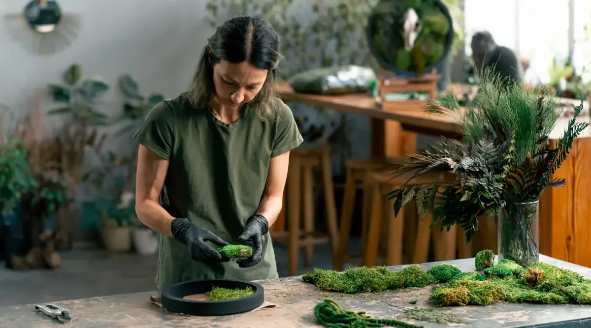 A florist works while she waits for her LLC formation paperwork.