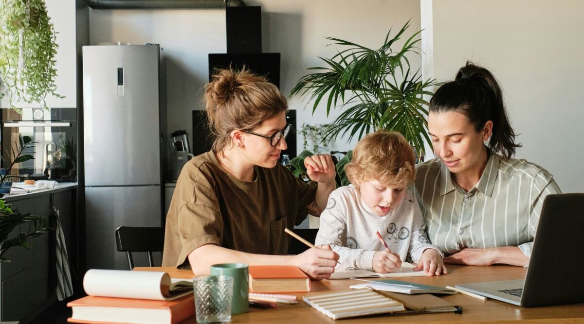 A couple reviews their last will and testament while their child looks on.