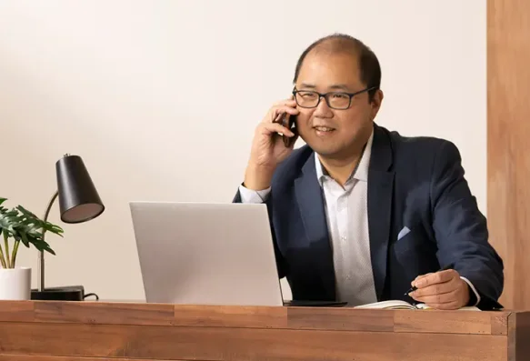 Asian man works at his desk