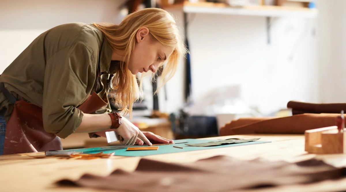 Woman focused on crafting project in workshop