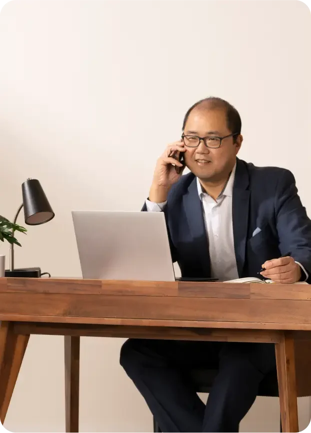 Asian man works at his desk