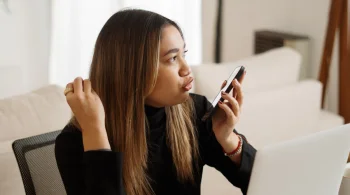 Woman speaking into phone, looking intent