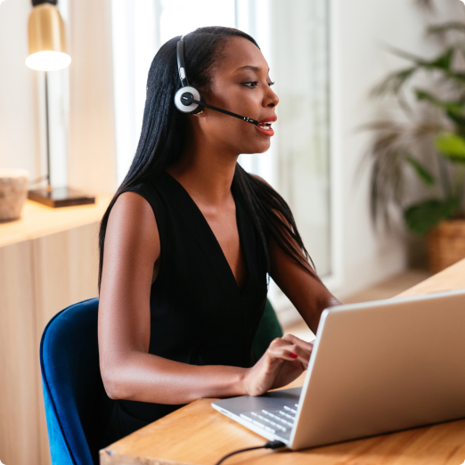 African American woman takes calls on her headset