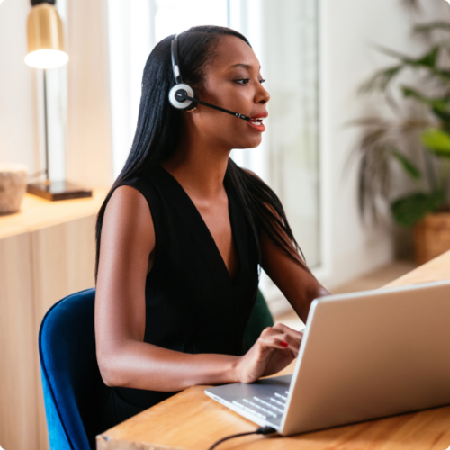 African American woman takes calls on her headset