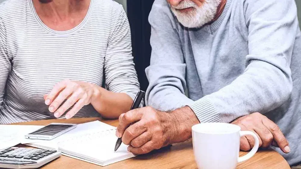 A woman and man seated at a table take notes on estate planning. In Florida, you need to follow specific steps to file your last will and testament for probate within 10 days following your death.