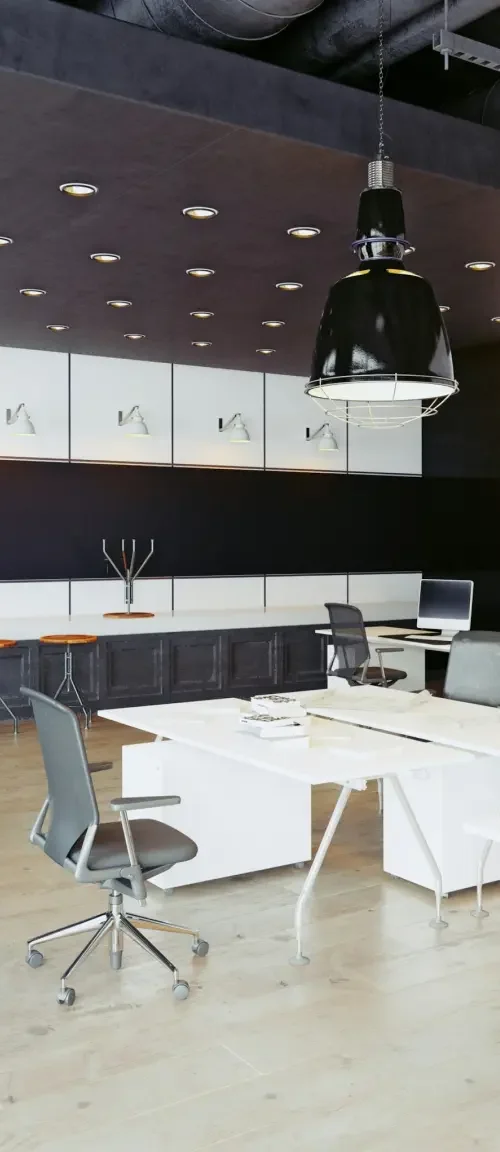 An office filled with desks, chairs, and desktop computers that a company is renting via a commercial lease agreement