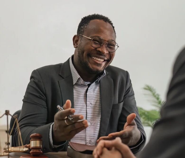 A man laughs during a meeting with his attorney