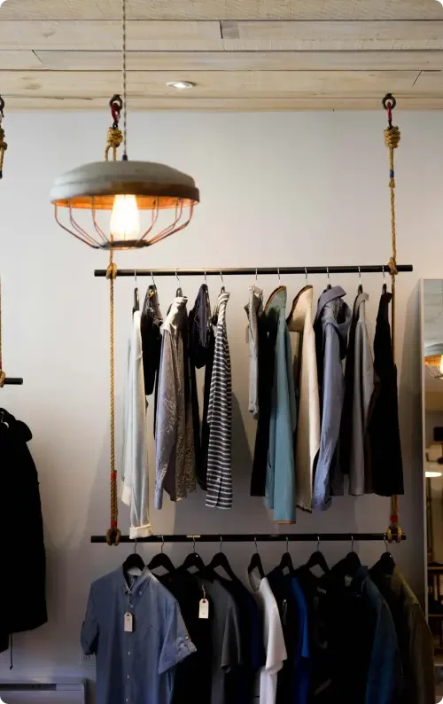 A store filled with clothes on racks that a retail company is renting via a commercial lease agreement