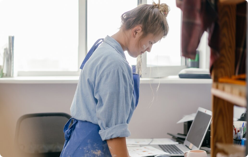 A woman standing in front of the desk